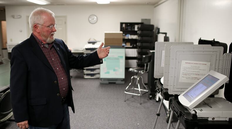 Merle King, executive director for the Center for Election Systems at Kennesaw State University, explains how a DRE, a touchscreen machine voters use when casting their ballot, works, Thursday, Oct. 20, 2016, in Kennesaw, Ga. BRANDEN CAMP/SPECIAL