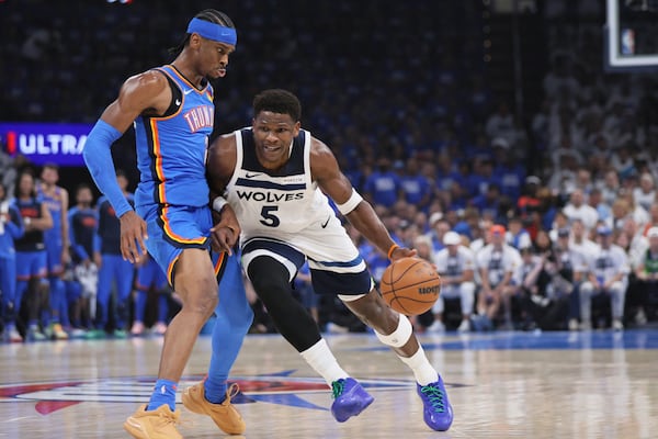 Minnesota Timberwolves guard Anthony Edwards (5) works toward the basket as Oklahoma City Thunder guard Shai Gilgeous-Alexander (2) defends during the first half of Game 5 of the Western Conference finals of the NBA basketball playoffs, Wednesday, May 28, 2025, in Oklahoma City. (AP Photo/Nate Billings)
