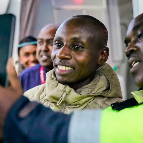 Sabastian Sawe poses for a selfie with an airport worker after arriving on a plane from London, Wednesday, April 29, 2026, at Jomo Kenyatta International Airport in Nairobi, Kenya, after setting a new world record in the marathon. (AP Photo/Brian Inganga) CORRECTION: Corrects spelling of first name to Sabastian, not Sebastian