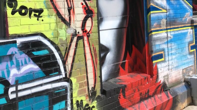 Graffiti decorates the walls of the Wedge Brewing and 12 Bones Smokehouse complex in Asheville’s River Arts District. PHOTO CREDIT: Bob Townsend.