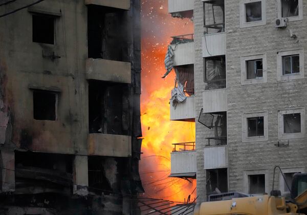 Flames rise between two buildings after an Israeli airstrike on Dahiyeh in the southern suburb of Beirut, Lebanon, Sunday, April 27, 2025. (AP Photo/Hussein Malla)