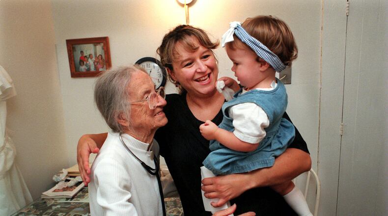 EMBRACING HER DOCTER--Scarlett Jimison (cq), center, and her 14-month-old daughther, Amber (cq), hug 100-year-old Dr. Leila Denmark (cq), goodbye after an office visit at her125-year-old farmhouse on Monday, September 14, 1998.  Jimison, who is from Buckhead, Ga., has been coming to Denmark since she was an infant and now brings her daughter. Amber was suffering from a cold.  (CURTIS COMPTON/staff)