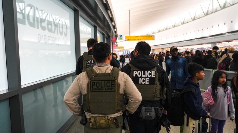 Federal immigration agents walk through Terminal 5 at John F. Kennedy International Airport (JFK) in the Queens borough of New York, Monday, March 23, 2026. (AP Photo/Ryan Murphy)