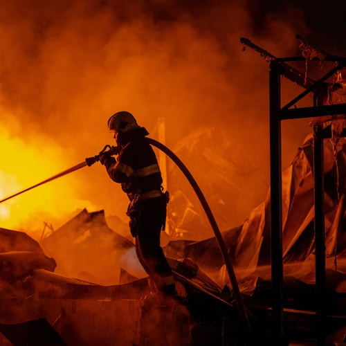 Firefighters put out a fire after Russian missiles hit a warehouse in Kyiv, Ukraine, Wednesday, Aug. 5, 2026. (AP Photo/Dan Bashakov)