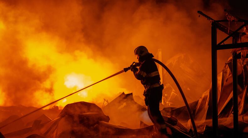 Firefighters put out a fire after Russian missiles hit a warehouse in Kyiv, Ukraine, Wednesday, Aug. 5, 2026. (AP Photo/Dan Bashakov)