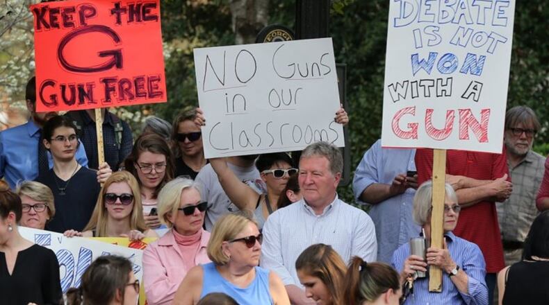 Students, faculty, staff and local residents hold a protest against campus carry legislation at the University of Georgia Arch on Tuesday, March 21, 2017, in Athens. Curtis Compton/ccompton@ajc.com