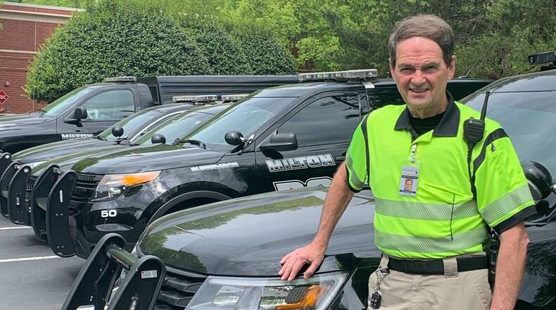 Milton Public Safety Ambassador Jack Odom with some of the city's public safety fleet. (Courtesy Milton Police Department)