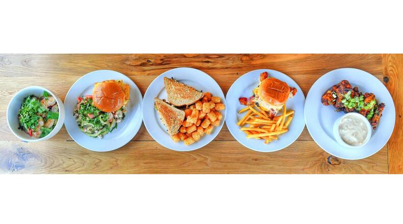 From left: Crunchy Asian Veggie Salad, Tempura Filet o' Fish, Double-Stacked Collard Green Melt, The Tower Of Power Burger, House Smoked Wings. CONTRIBUTED BY CHRIS HUNT PHOTOGRAPHY