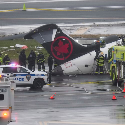 FILE - Firefighters and investigators examine the site, March 23, 2026, where an Air Canada jet came to rest after colliding with a Port Authority firetruck at LaGuardia Airport, after landing Sunday night in New York. (AP Photo/Seth Wenig, File)