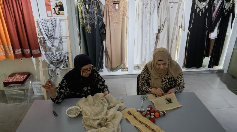 Palestinian weavers Rula Barakeh, right, and Samira Nasser work on handmade embroidered pieces at the Inaash Association embroidery workshop in Beirut, Tuesday, May 19, 2026. (AP Photo/Bilal Hussein)