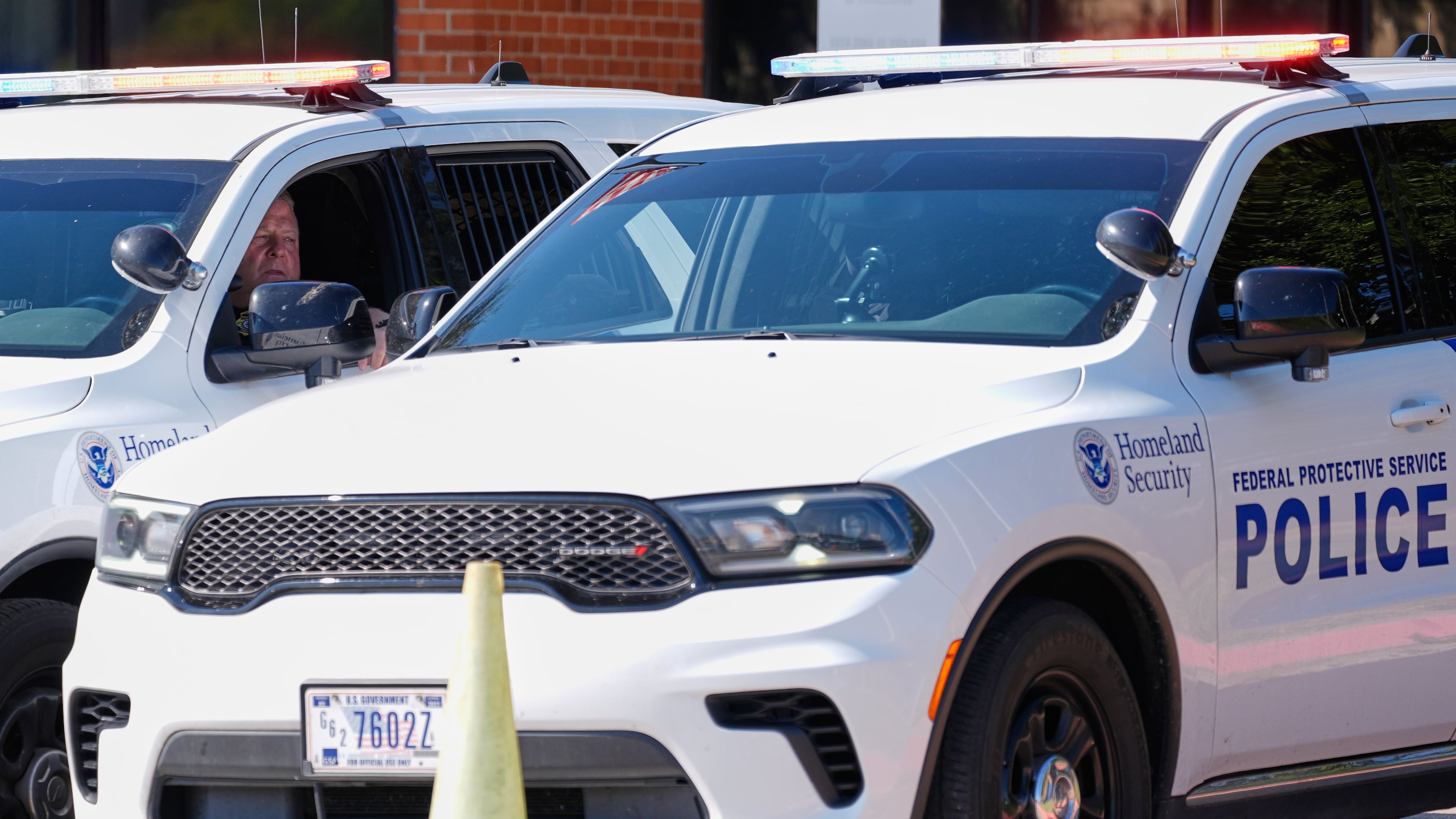 Homeland security personnel sit in their vehicles in front of the U.S. Immigration and Customs Enforcement office Thursday, Sept. 25, 2025, in Dallas. (AP Photo/Tony Gutierrez)