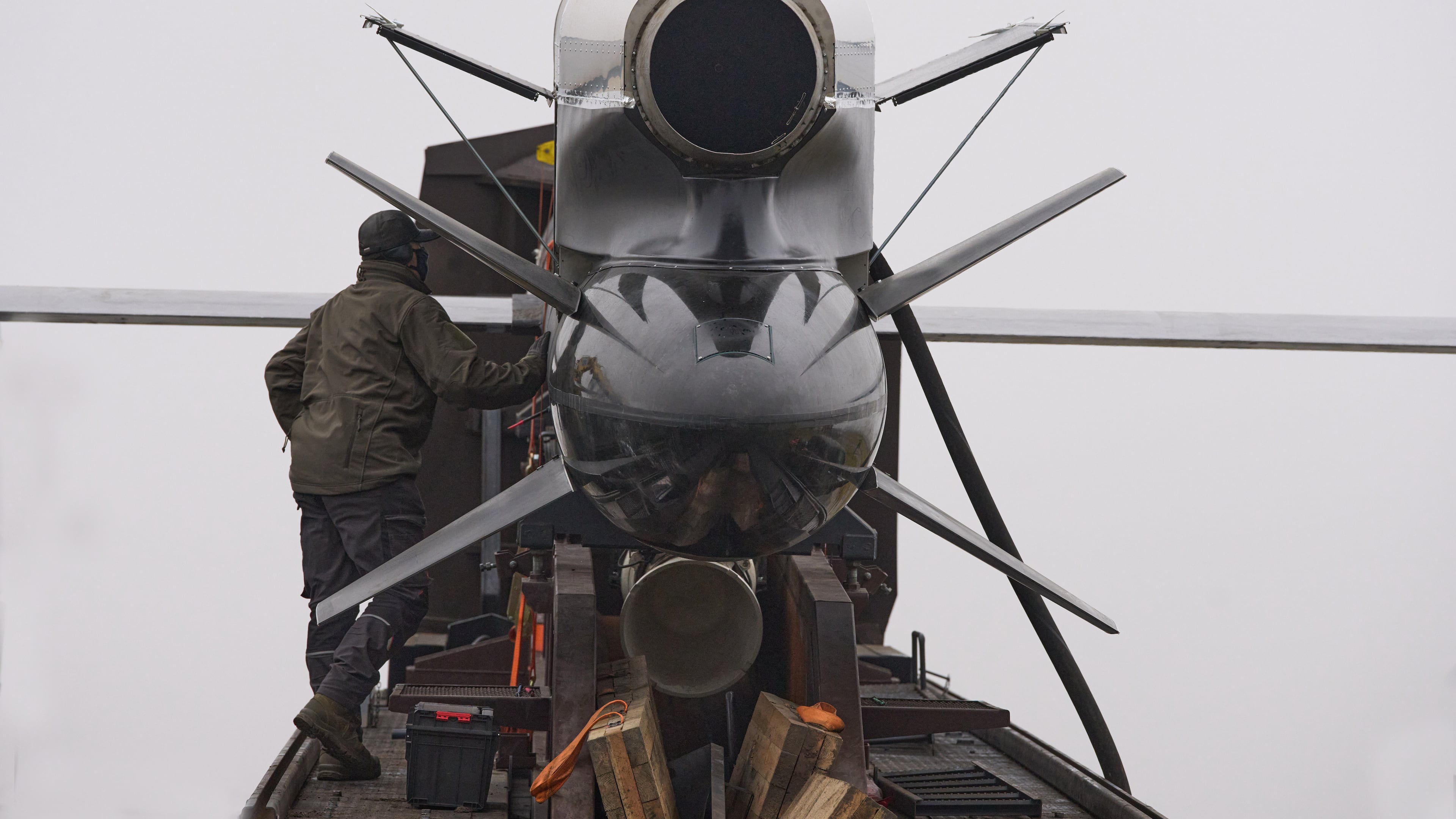 Workers and military inspect Ukrainian Fire Point's Flamingo missiles during handover to the military in an undisclosed location in Ukraine Thursday, Dec. 4, 2025. (AP Photo/Efrem Lukatsky)