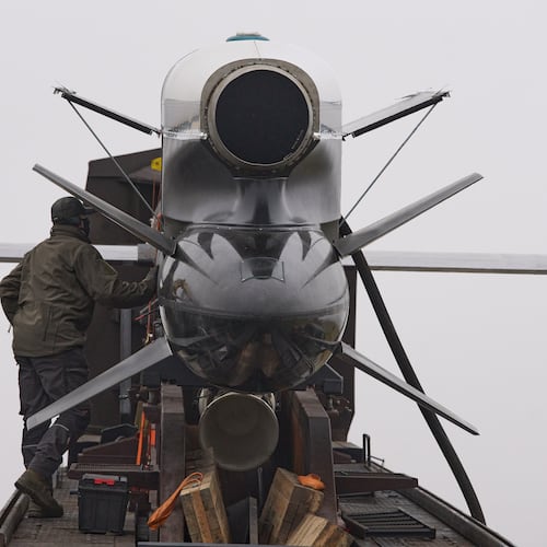 Workers and military inspect Ukrainian Fire Point's Flamingo missiles during handover to the military in an undisclosed location in Ukraine Thursday, Dec. 4, 2025. (AP Photo/Efrem Lukatsky)