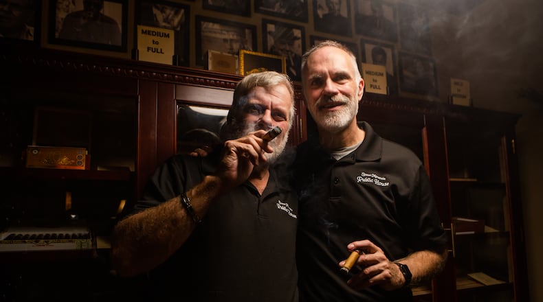 Rory Webb (left) and Jeff Carey (right), owners of Stone Mountain Public House, pose for a portrait on Saturday, January 23, 2021, at Stone Mountain Public House in Stone Mountain, Georgia. Webb and Carey were forced to close Stone Mountain Public House due to the coronavirus pandemic, but are applying for a relief grant to help fund its reopening as a piano bar and cigar lounge. CHRISTINA MATACOTTA FOR THE ATLANTA JOURNAL-CONSTITUTION
