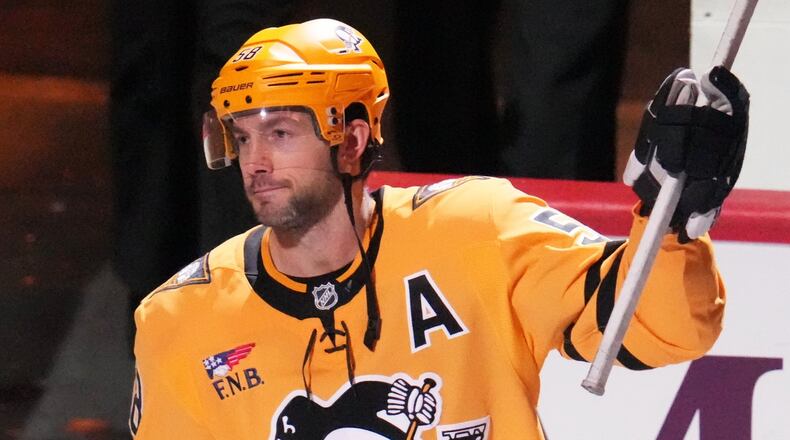 Pittsburgh Penguins' Kris Letang acknowledges being named the games number one start after scoring the gamin-winning goal in the overtime period of an NHL hockey game against the Detroit Red Wings in Pittsburgh, Thursday, Jan. 1, 2026. (AP Photo/Gene J. Puskar)