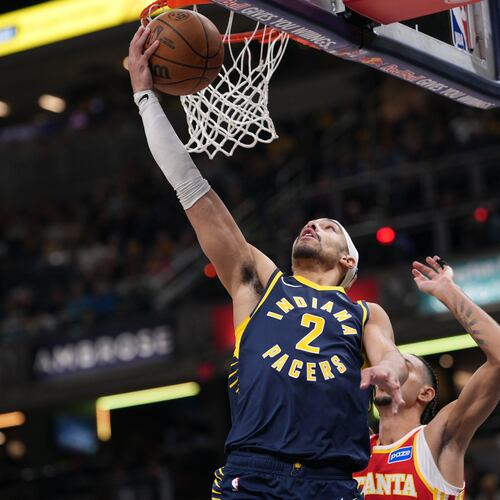 Indiana Pacers guard Andrew Nembhard, left, shoots in front of Atlanta Hawks forward Zaccharie Risacher during the first half of an NBA basketball game in Indianapolis, Saturday, Jan. 31, 2026. (AP Photo/AJ Mast)