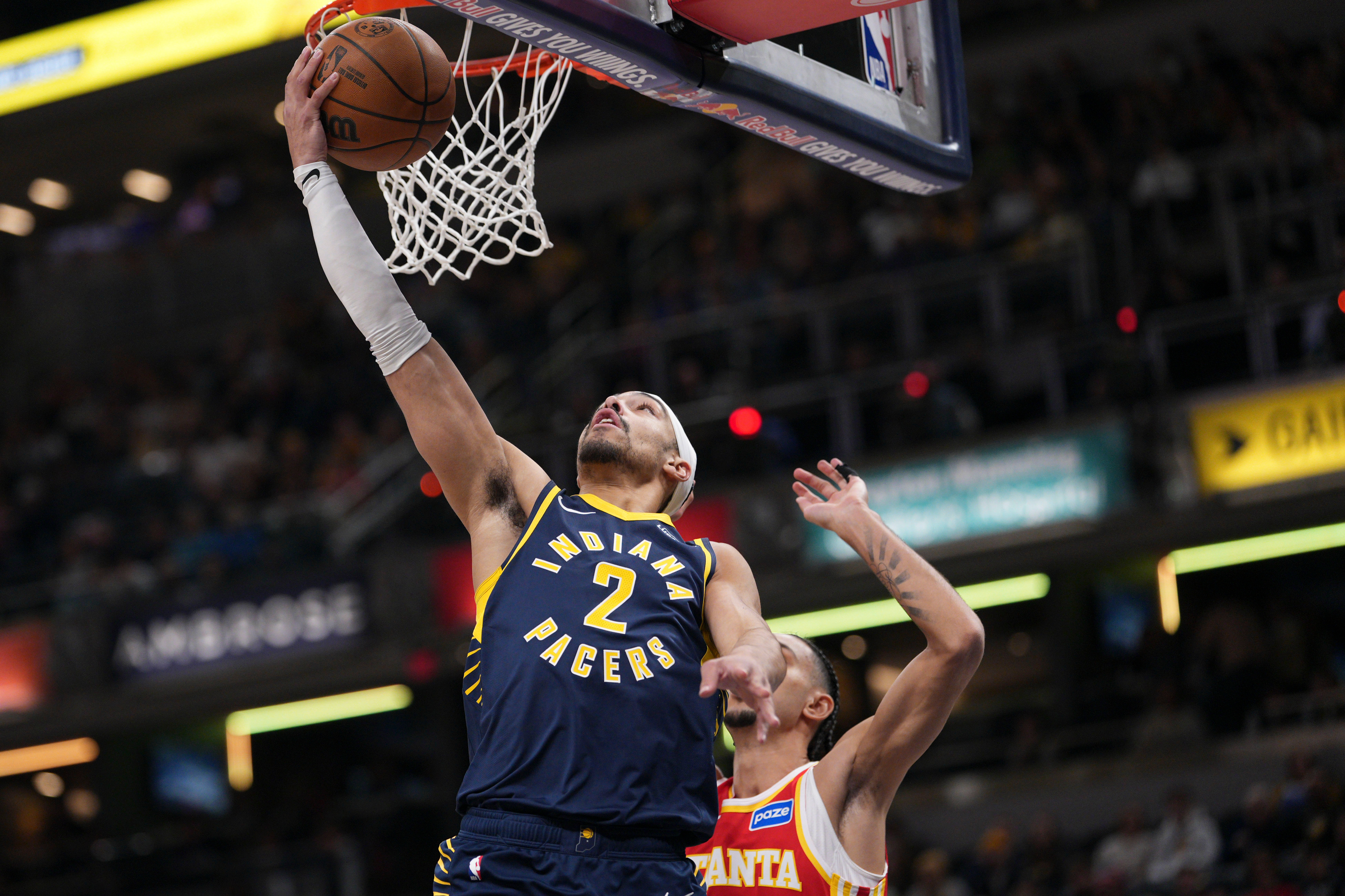 Indiana Pacers guard Andrew Nembhard, left, shoots in front of Atlanta Hawks forward Zaccharie Risacher during the first half of an NBA basketball game in Indianapolis, Saturday, Jan. 31, 2026. (AP Photo/AJ Mast)