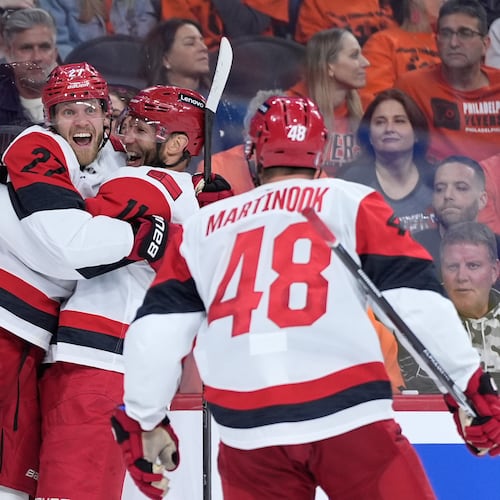 Carolina Hurricanes' Nikolaj Ehlers, from left, Jordan Staal and Jordan Martinook celebrate after a goal by Ehlers during the third period of Game 3 in the second round of the NHL hockey Stanley Cup playoffs against the Philadelphia Flyers Thursday, May 7, 2026, in Philadelphia. (AP Photo/Matt Slocum)