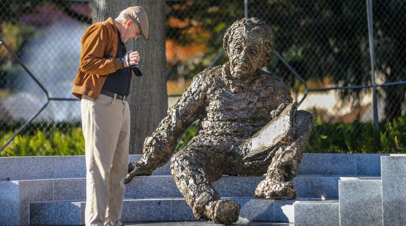 In this 2015 file photo, Jim Barksdale examines the star chart on the ground at the feet of the new Albert Einstein monument at Georgia Tech. John Spink, jspink@ajc.com