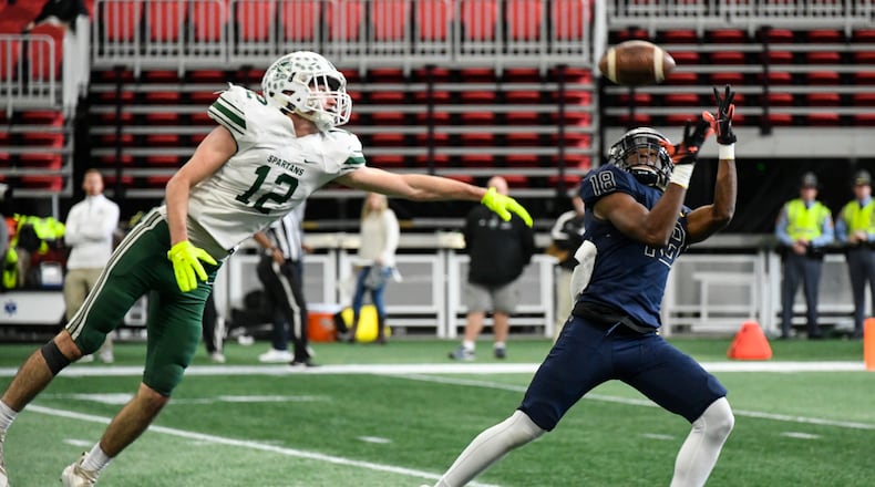 Eagle's Landing Christian Academy's Justin Menard makes a catch as Athens Academy LB Barrett McLanahan defends during the third quarter of Wednesday's Class A private state title game at Mercedes-Benz Stadium. (John Amis/Special)