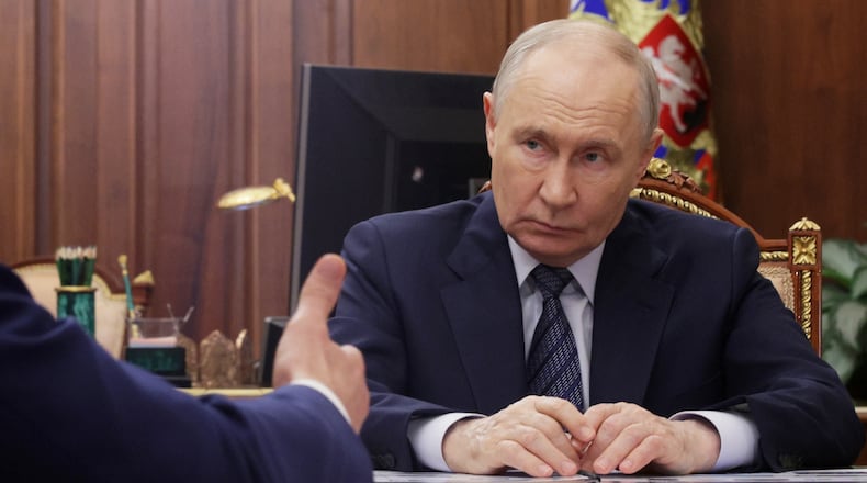 Russian President Vladimir Putin listens to Minister of Industry and Trade Anton Alikhanov during their meeting at the Kremlin in Moscow, Wednesday, Aug. 26, 2026. (Mikhail Metzel, Sputnik, Kremlin Pool Photo via AP)