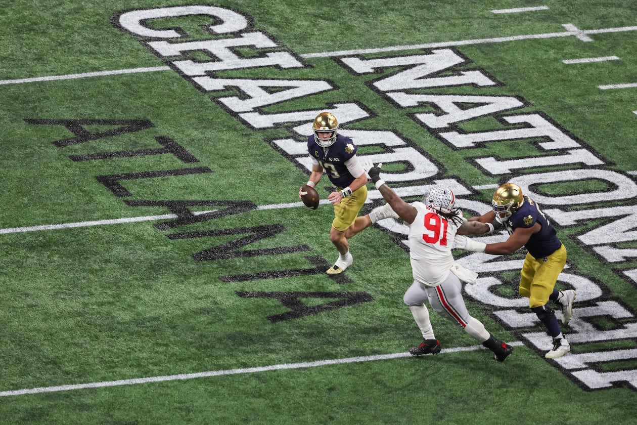 Notre Dame quarterback Riley Leonard (13) runs against Ohio State defensive tackle Tyleik Williams (91) during the first half of the 2025 National Championship at Mercedes-Benz Stadium, Monday, Jan. 20, 2025, in Atlanta. (Jason Getz/AJC)