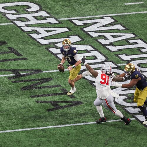 Notre Dame quarterback Riley Leonard (13) runs against Ohio State defensive tackle Tyleik Williams (91) during the first half of the 2025 National Championship at Mercedes-Benz Stadium, Monday, Jan. 20, 2025, in Atlanta. (Jason Getz/AJC)