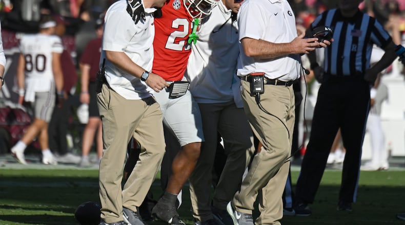 Georgia running back Branson Robinson (22) injured after he was tackled by Mississippi State safety Isaac Smith (2) during the first half in an NCAA football game at Sanford Stadium, Saturday, October 12, 2024, in Athens. Georgia won 41-31 over Mississippi State. (Hyosub Shin / AJC)