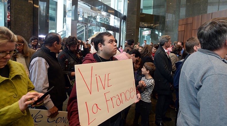 Marc Jamali of Atlanta holds a sign in solidarity with the Paris victims. A crowd of about 400 people gathered at the French Consulate in Atlanta on Sunday, Nov. 16, during a rally in support of the victims of the Paris terrorist attack. After brief remarks, the crowd sang "La Marseillaise," the French national anthem.