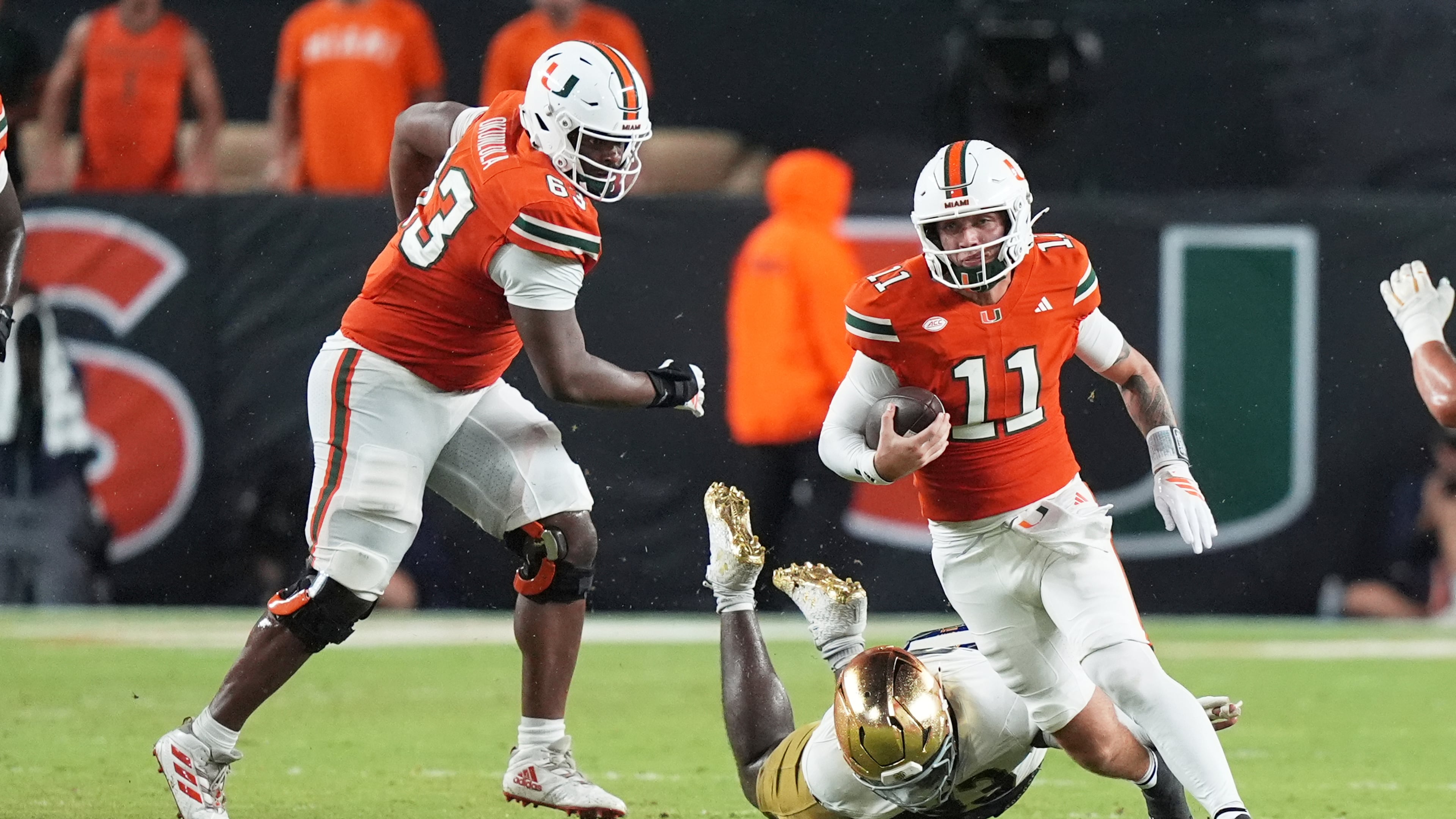 Miami quarterback Carson Beck (right) scrambles in the first half against Notre Dame on Sunday, Aug. 31, 2025, in Miami Gardens, Fla. The former Georgia star was 20-of-31 passing for 205 yards and two touchdowns in his first game for the Hurricanes, a 27-24 win over the Fighting Irish. (Lynne Sladky/AP)