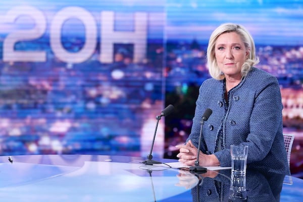 Far-right leader Marine Le Pen poses prior to an interview on the evening news broadcast of French TV channel TF1, after a French court convicted Marine Le Pen of embezzlement and barred her from seeking public office for five years, Monday, March 31, 2025, in Boulogne-Billancourt, outside Paris. (Thomas Samson, Pool via AP)