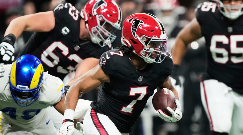 Atlanta Falcons running back Bijan Robinson (7) carries against the Los Angeles Rams in the first half of an NFL football game, Monday, Dec. 29, 2025, in Atlanta. (AP Photo/Brynn Anderson)