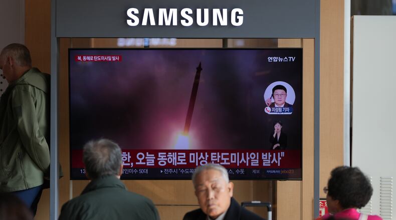A TV screen shows a reporting of North Korea's ballistic missiles with file footage during a news program at the Seoul Railway Station in Seoul, South Korea, Friday, Nov. 7, 2025. (AP Photo/Lee Jin-man)