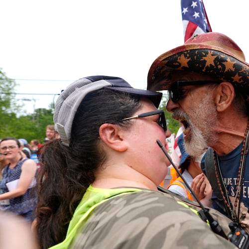 A man yells at a woman working security near a U.S. Immigration and Customs Enforcement facility in Scarborough, Maine, one day after the shooting of Johan Sebastián Durán Guerrero, Tuesday, July 14, 2026. (AP Photo/Robert F. Bukaty)