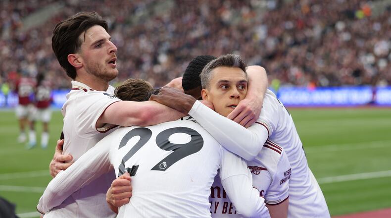 Arsenal players celebrate after scoring during the Premier League soccer match between West Ham and Arsenal in London, Sunday, May 10, 2026. (AP Photo/Ian Walton)