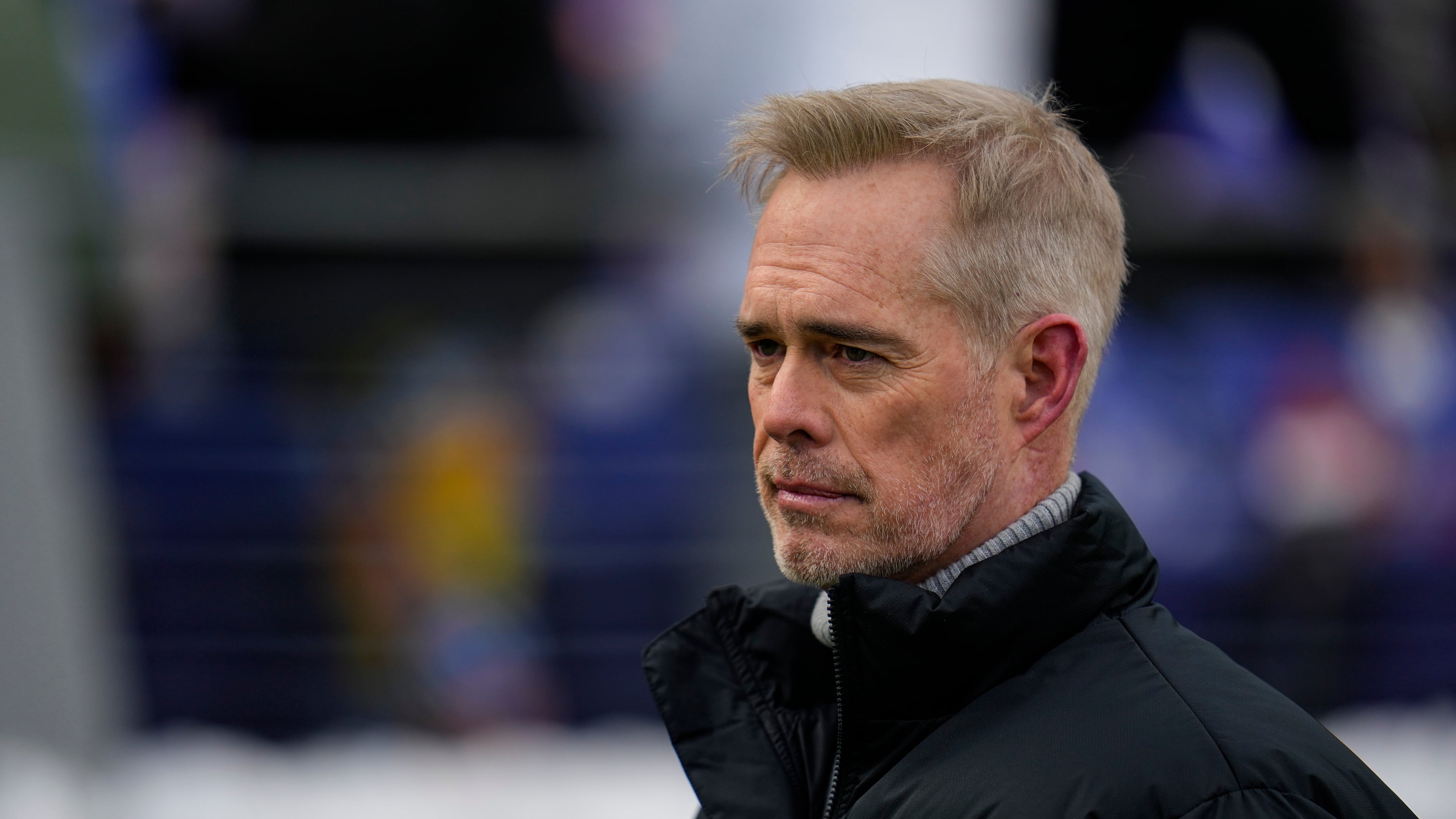 FILE - ESPN broadcaster Joe Buck walks the field before an NFL football AFC divisional playoff game between the Baltimore Ravens and the Houston Texans, Jan. 20, 2024, in Baltimore. (AP Photo/Julio Cortez, File)