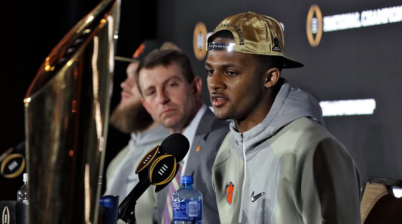 Clemson quarterback Deshaun Watson, right, answers a question during a news conference Tuesday, Jan. 10, 2017, in Tampa, Fla. Clemson defeated Alabama 35-31 in the College Football Playoff championship game the night before. Looking on at left is coach Dabo Swinney. (AP Photo/Chris O’Meara)