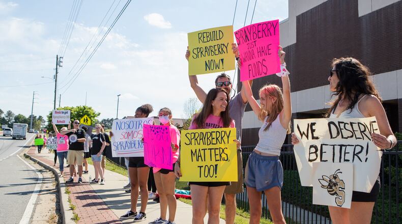 Students, teachers and community members demonstrate in front of Sprayberry High School during on Sunday, April 18, 2021, in Marietta, Georgia. Parents and community members held the rally to encourage Cobb County school board members to allocate funds to renovate the school. CHRISTINA MATACOTTA FOR THE ATLANTA JOURNAL-CONSTITUTION
