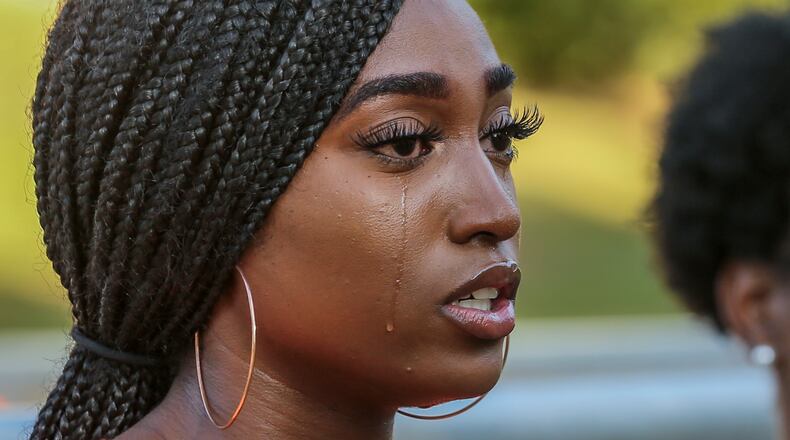 19-year old Clark Atlanta University student, Kia Thomas sheds a tear as she spoke to the media at Cleopas R. Johnson Park Friday morning, August 23, 2019 about the shooting on campus where a bullet grazed her. Hours before the start of a new school year, four students were injured in a shooting at a block party Tuesday night outside the Atlanta University Center library. Two Spelman College students and two Clark Atlanta University students, all of whom are women, were taken to a hospital with injuries ranging from graze wounds to gunshot wounds, according to Atlanta police. They were hit around 10:30 p.m., when someone opened fire into a crowd of about 200 people in front of the Robert W. Woodruff Library on James P. Brawley Drive. JOHN SPINK/JSPINK@AJC.COM