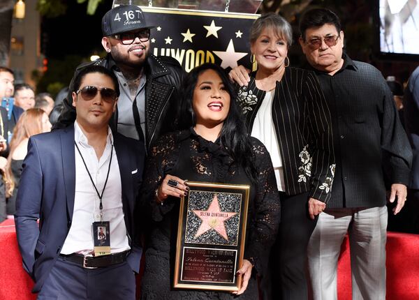 FILE - Suzette Quintanilla, center, sister of the late singer Selena Quintanilla, holds a replica of Selena's star on the Hollywood Walk of Fame as she poses with, from left, Selena's husband Chris Perez, her brother A.B. Quintanilla III, and her parents Marcella Ofelia Samora and Abraham Quintanilla Jr. during a posthumous ceremony on the Hollywood Walk of Fame in Los Angeles on Nov. 3, 2017. (Photo by Chris Pizzello/Invision/AP, File)