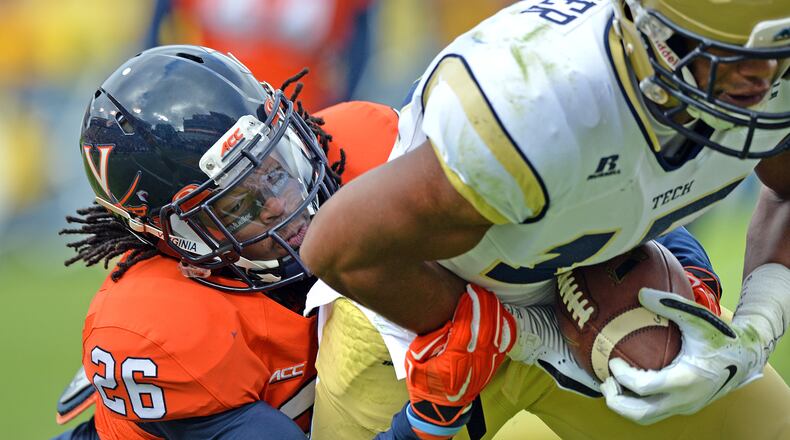 Georgia Tech Yellow Jackets wide receiver DeAndre Smelter (15) breaks away from Virginia Cavaliers cornerback Maurice Canady (26) for a touchdown in the first half at Bobby Dodd Stadium on Saturday, November 1, 2014. HYOSUB SHIN / HSHIN@AJC.COM