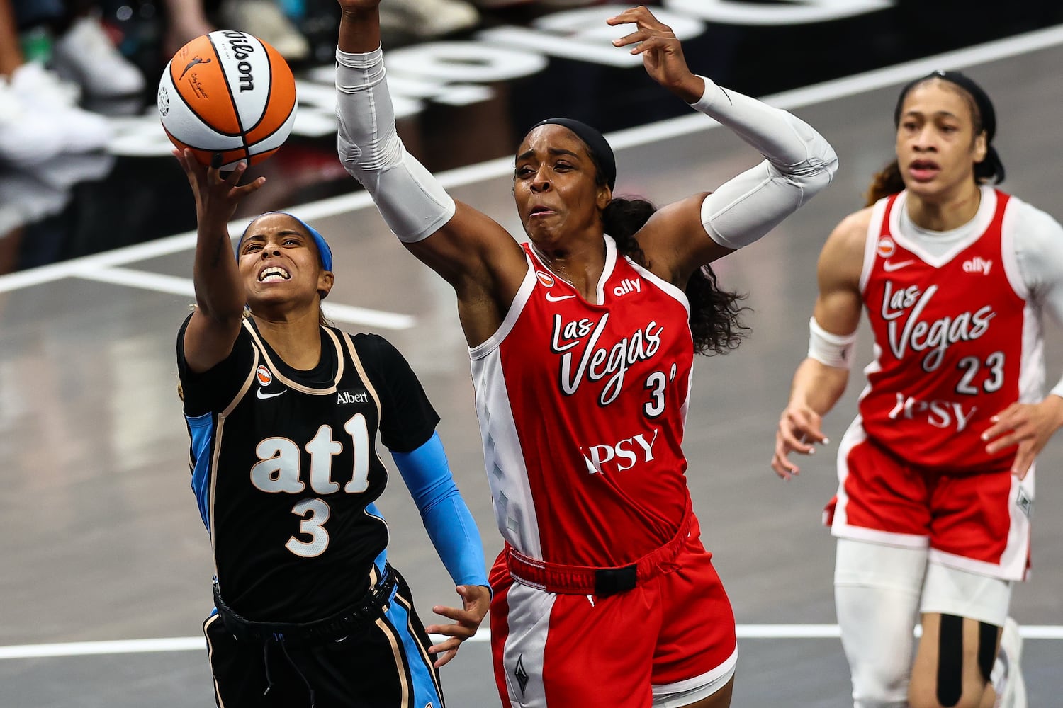 Atlanta Dream guard Jordin Canada (3) shoots against Las Vegas Aces forward Cheyenne Parker-Tyus, center, during the second half of a WNBA game at State Farm Arena on Sunday, May 17, 2026, in Atlanta. (Colin Hubbard for the AJC) 