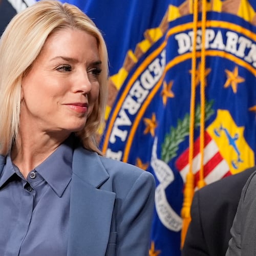 Attorney General Pam Bondi and FBI Director Kash Patel look at each other during a news conference at the Department of Justice, Thursday, Dec. 4, 2025, in Washington. (AP Photo/Alex Brandon)