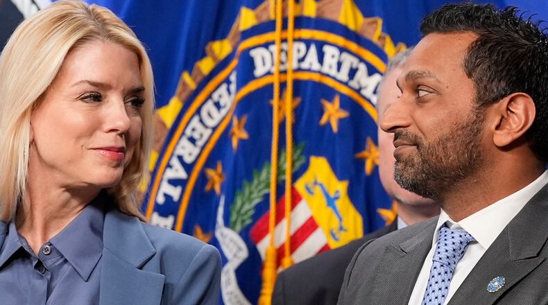 Attorney General Pam Bondi and FBI Director Kash Patel look at each other during a news conference at the Department of Justice, Thursday, Dec. 4, 2025, in Washington. (AP Photo/Alex Brandon)