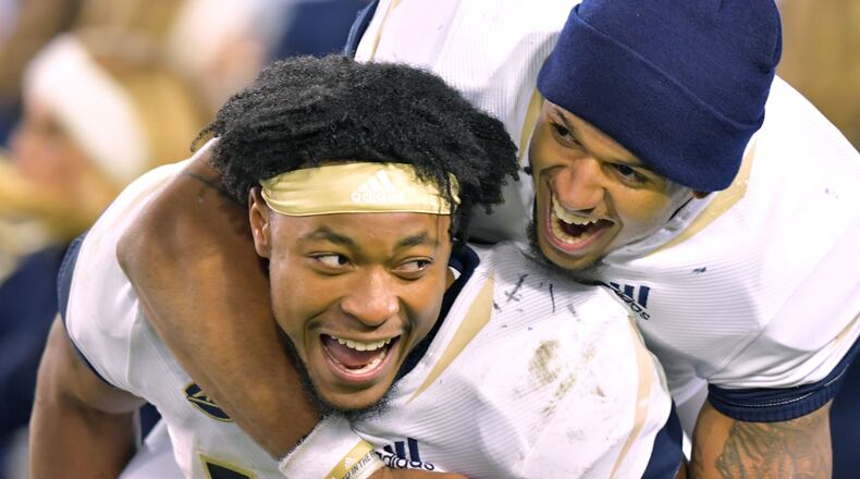 Georgia Tech TaQuon Marshall (16) and Tobias Oliver (8) celebrate their victory over the Miami at Bobby Dodd Stadium on Saturday, November 10, 2018. Georgia Tech won 27 - 21 over the Miami. HYOSUB SHIN / HSHIN@AJC.COM