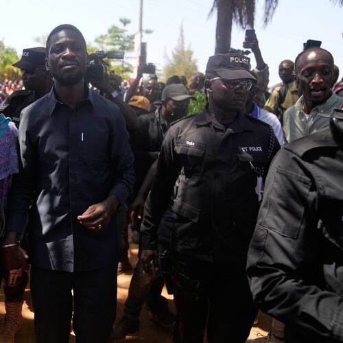 Uganda opposition presidential candidate Robert Kyagulanyi Ssentamu, famously known as Bobi Wine of the National Unity Platform (NUP), arrives with his wife to cast their votes, during the presidential election at a polling station, in Kampala, Uganda, Thursday, Jan. 15, 2026. (AP Photo/Brian Inganga)