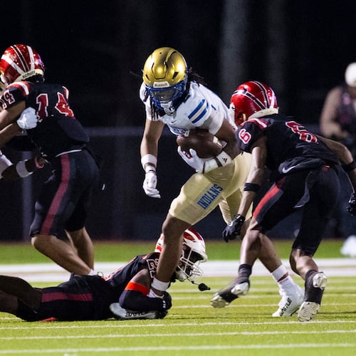 McEachern wide receiver Nalin Scott (2) dodges a tackle against Hillgrove at Cobb Energy Hillgrove Stadium in Powder Springs, on Friday, Oct. 17, 2025. (Oscar Guevara Saenz for the AJC)