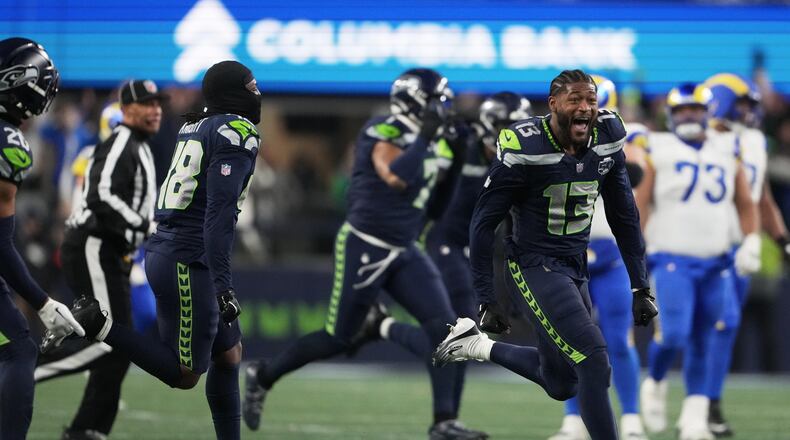 Seahawks linebacker Ernest Jones (right) celebrates after the NFC championship game victory over the Rams on Sunday, Jan. 25, 2026, in Seattle. Jones starred in high school at Ware County. (Lindsey Wasson/AP)