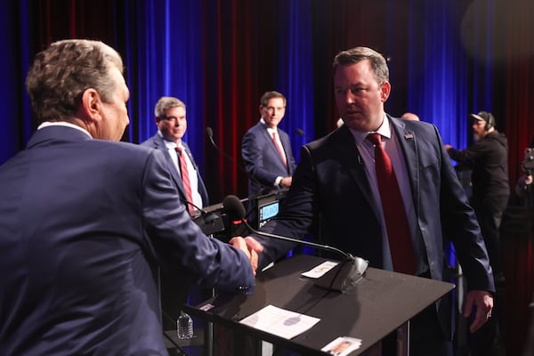 Republican candidates for governor Rick Jackson (left) and Lt. Gov. Burt Jones shake hands before the Atlanta Press Club Loudermilk-Young debate at Georgia Public Broadcasting on Monday. (Arvin Temkar/AJC)