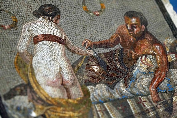 A Roman mosaic depicting a pair of lovers, which was repatriated from Germany, is displayed to journalists in the auditorium of Pompeii archaeological park, Tuesday, July 15, 2025. (AP Photo/Gregorio Borgia)